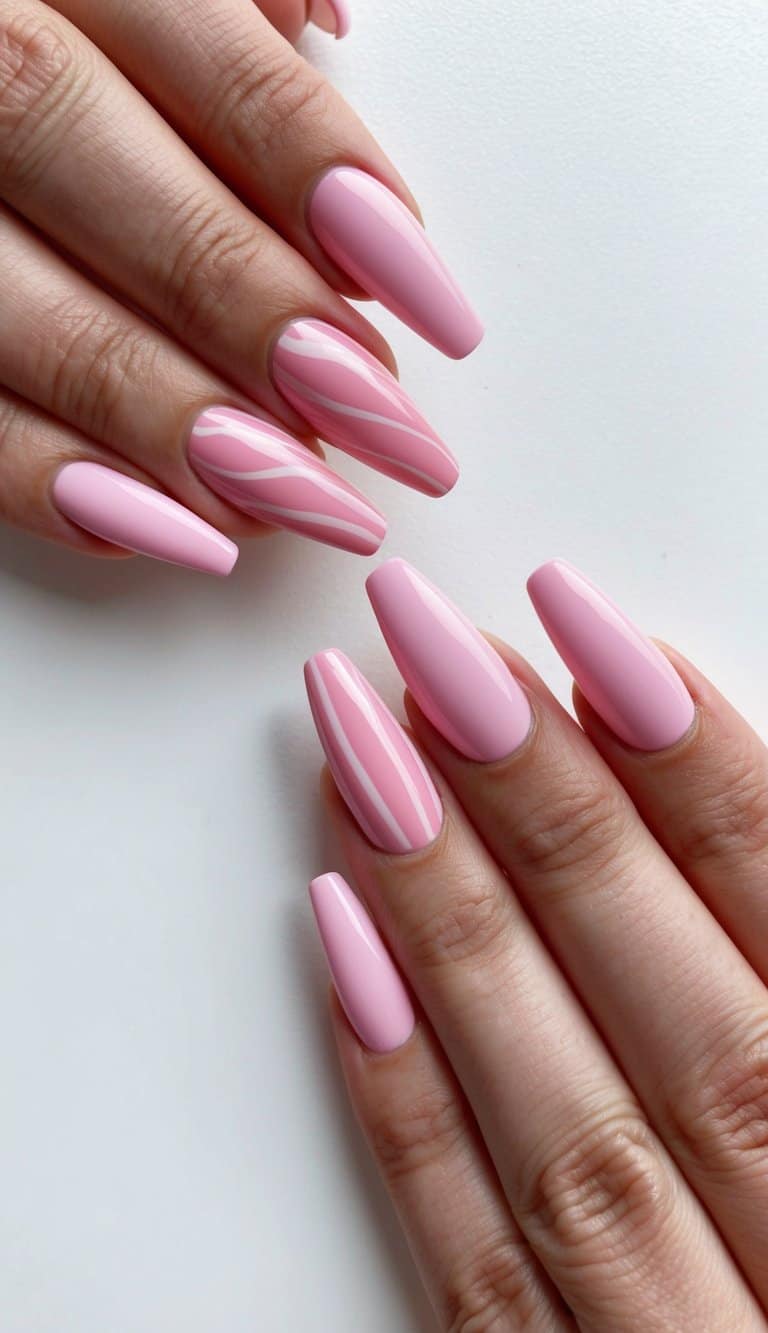 Soft pink ombre nails with raspberry ripple swirls and delicate patterns on a white background
