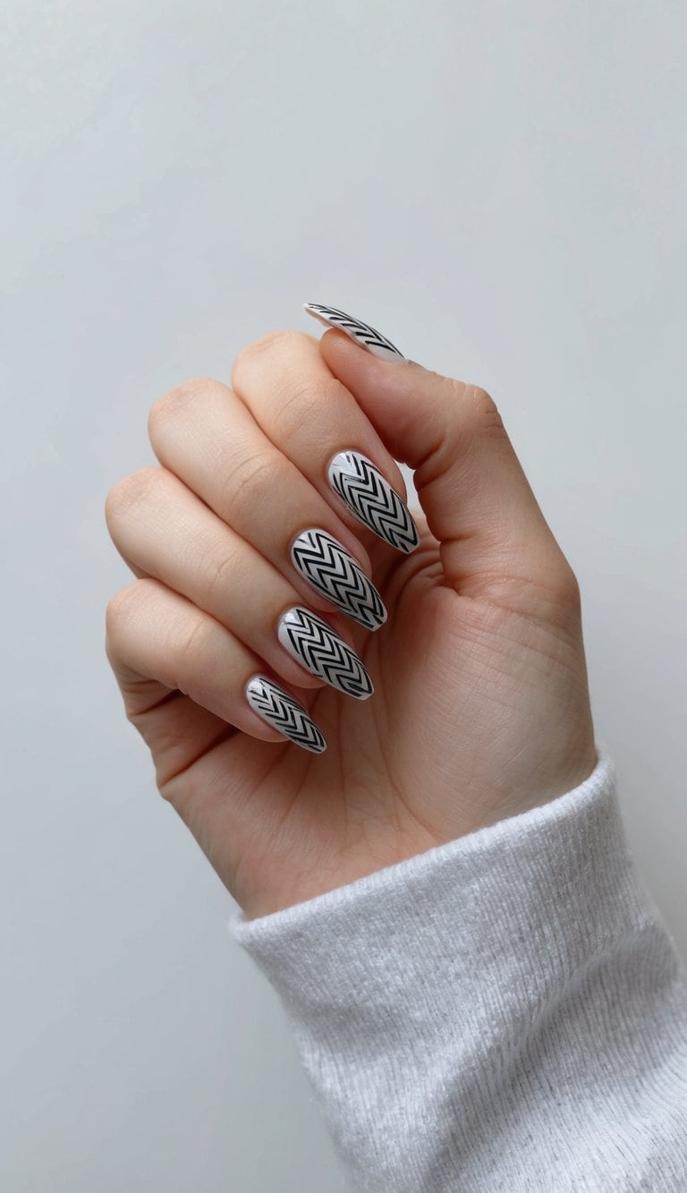 A hand with finely detailed zigzag nail art designs
