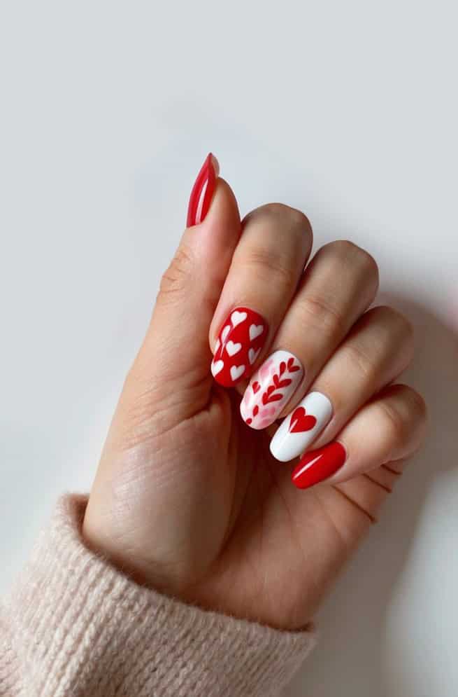 Romantic hearts on red, pink, and white nails