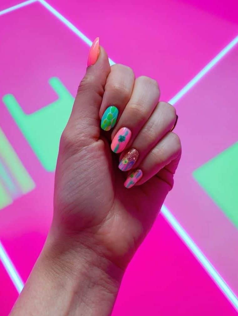 A neon pink dance floor with various spring-themed nail art designs displayed on a vibrant pink background