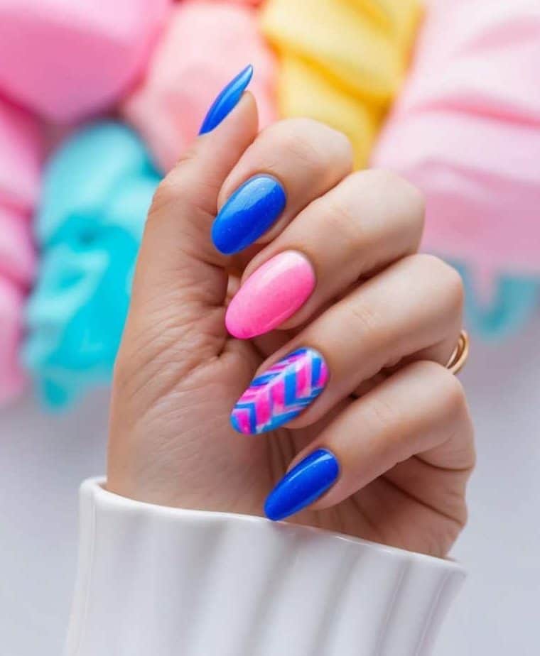 Vibrant blue and pink nail art designs with a chevron accent nail in the same striking colors