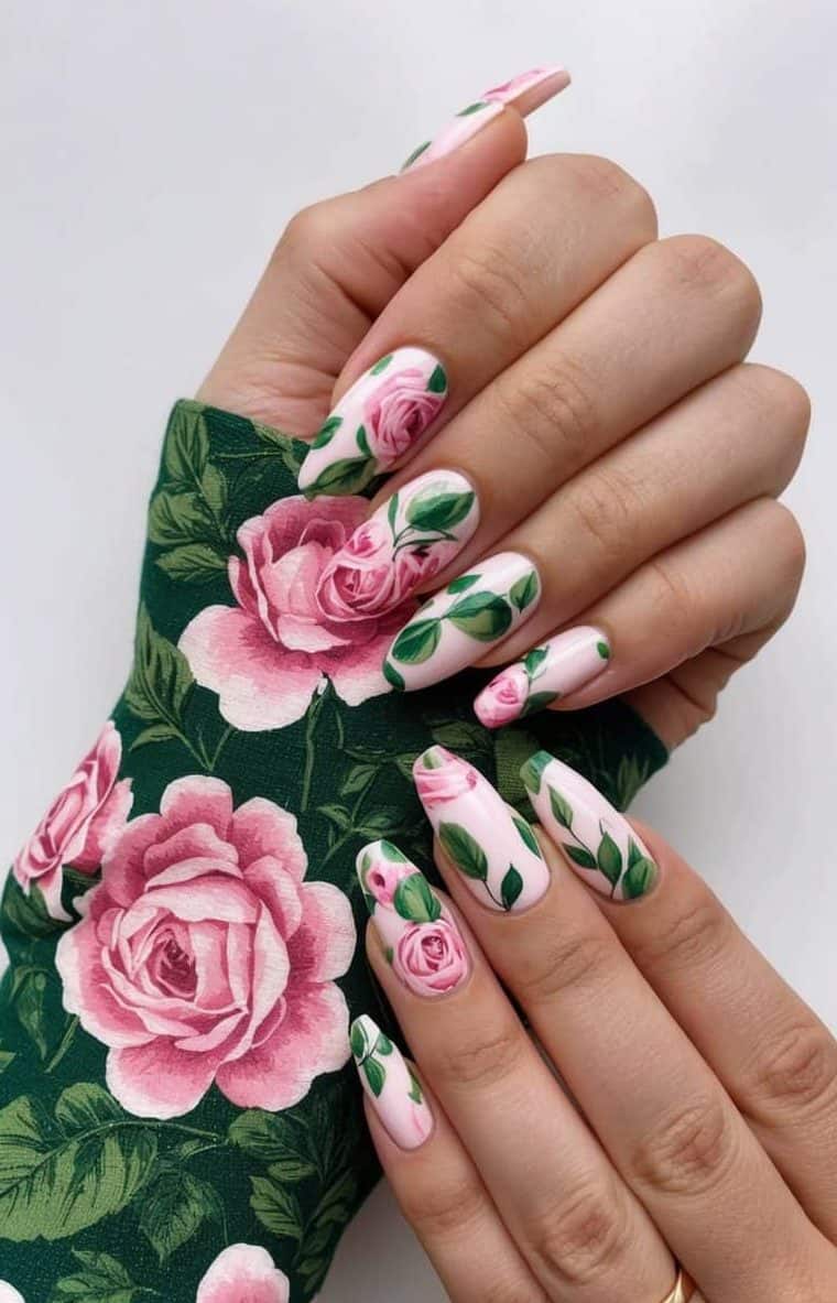 A lush floral pattern featuring pink roses and green leaves for nail art inspiration