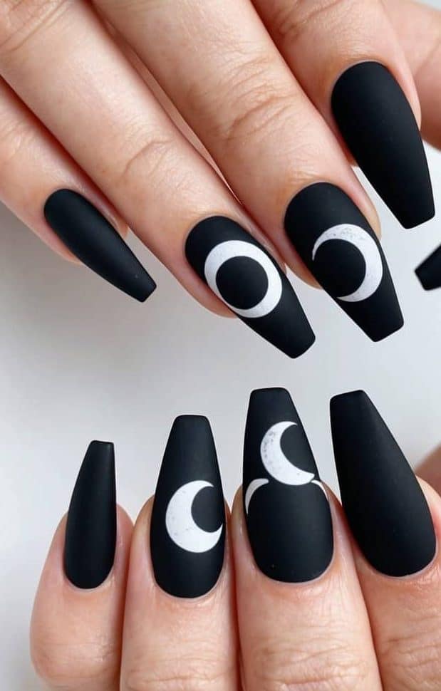 Mesmerizing moon nail art on matte black nails