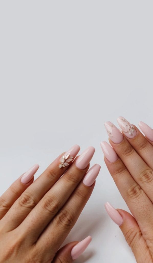 Blush pink bridal nails with leaf rhinestone embellishments