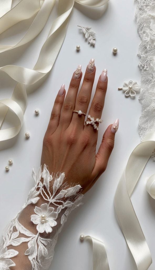 Soft pink nails are elevated with 3D floral accents and rhinestones