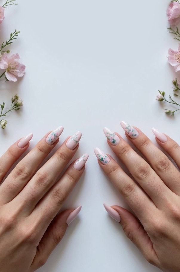 Whimsical and vibrant-colored floral accents bloom over soft pink nails
