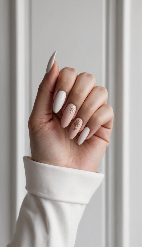A trendy formal nail design featuring nude matte nails with a gold embellishment on one accent nail, blending minimal elegance with a modern touch.