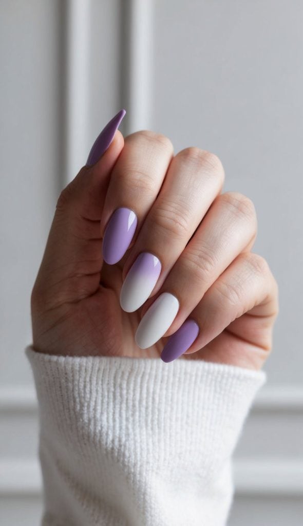 A hand with lavender and white ombre nails against a soft, elegant background