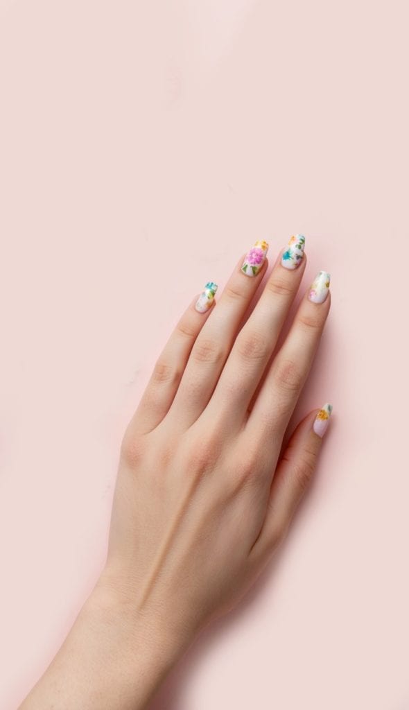 White nails with colorful blooms for a simple yet playful manicure