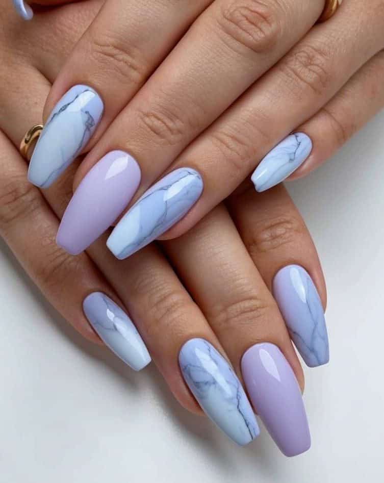 Dreamy periwinkle polish swirls with delicate marble veining, creating an ethereal marble effect