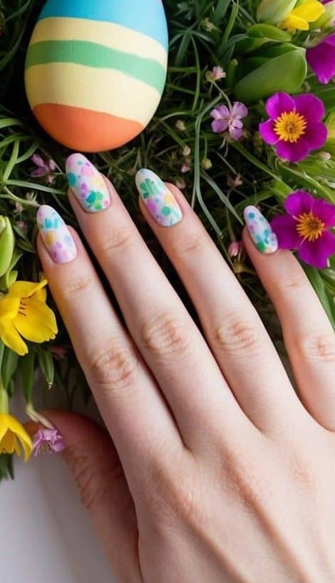 A colorful Easter egg nestled in a bed of vibrant spring flowers