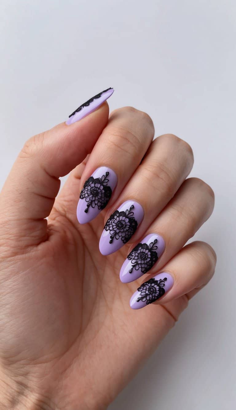 A close-up of lilac nails adorned with delicate black lace designs