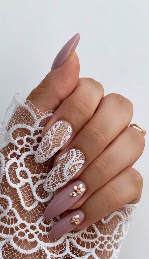 A delicate lace overlay in soft mauve tones with nail art designs displayed around it
