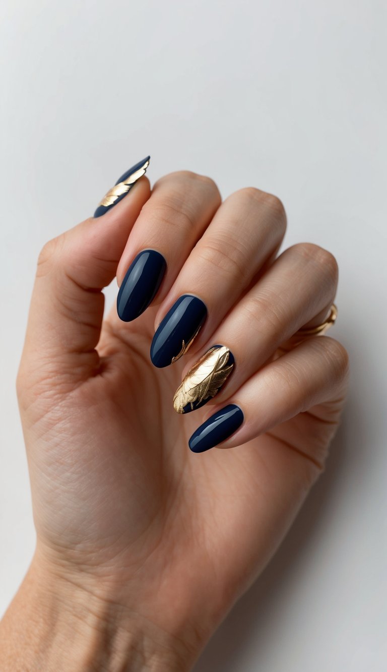 A close-up of navy blue nails adorned with intricate gold leaf details
