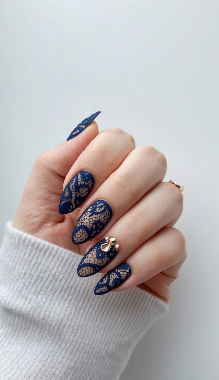 A close-up of navy blue nails with intricate lace patterns