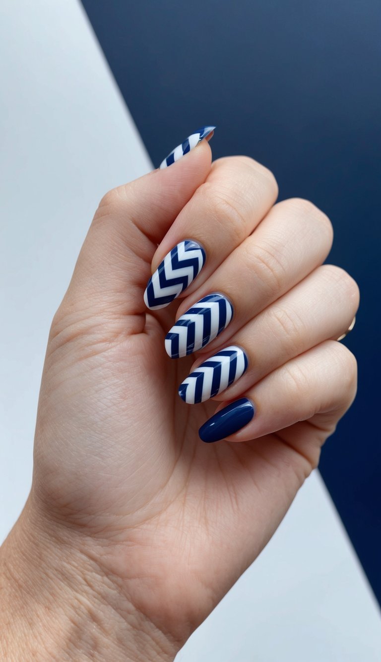 A close-up of navy blue chevron nail patterns on a dark background