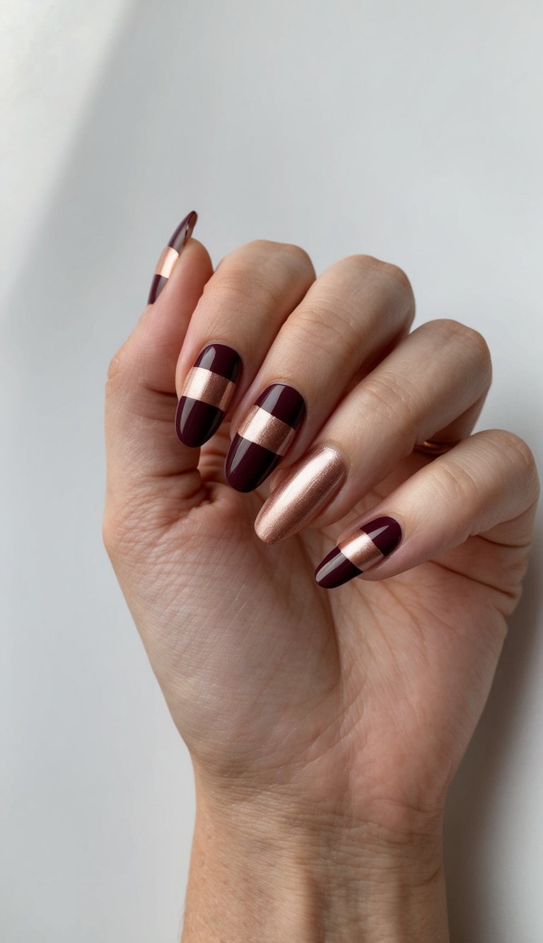 Maroon and rose gold stripes nail art on a clean, manicured surface