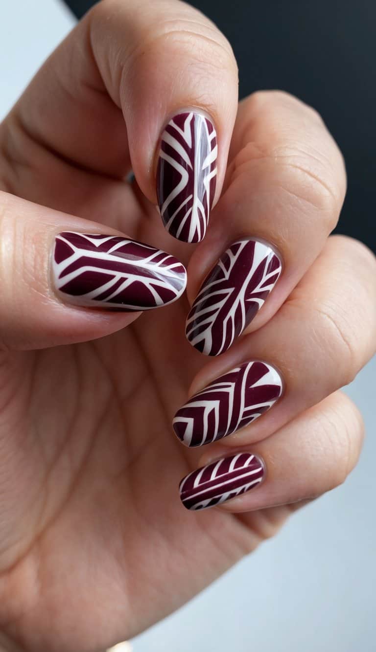 A close-up of maroon tribal patterns on nails, against a white background