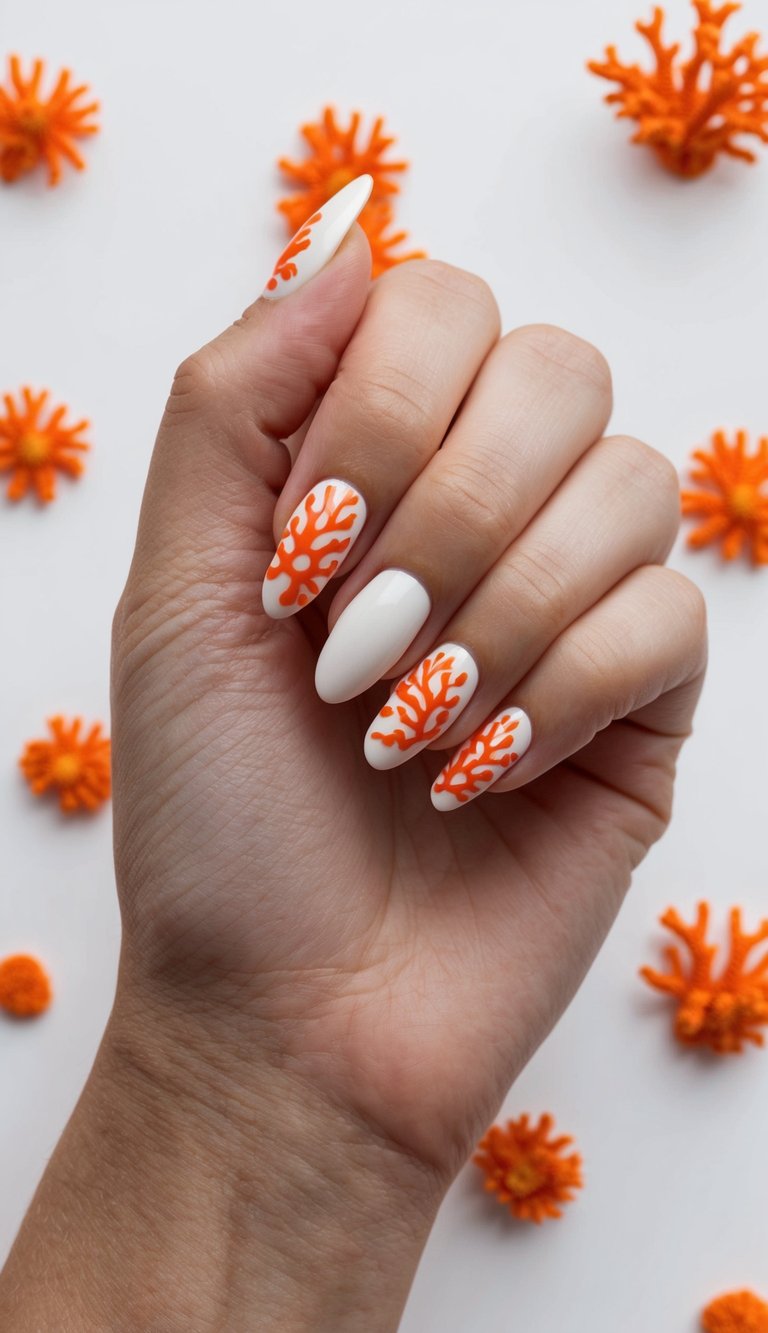 White nails featuring hand-drawn orange coral patterns, ideal for an artistic and ocean-themed nail design.