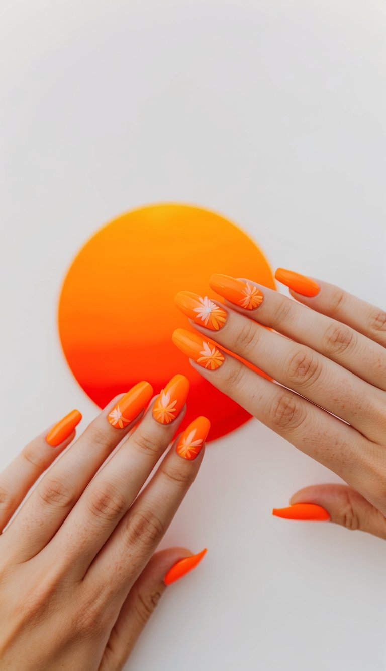 Neon orange nails with delicate white and pink daisy floral accents, bringing a cheerful floral pop to orange nail art.