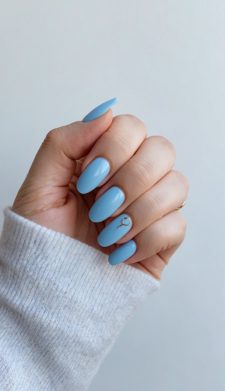 A hint of sky blue nail polish on a clean, minimal background