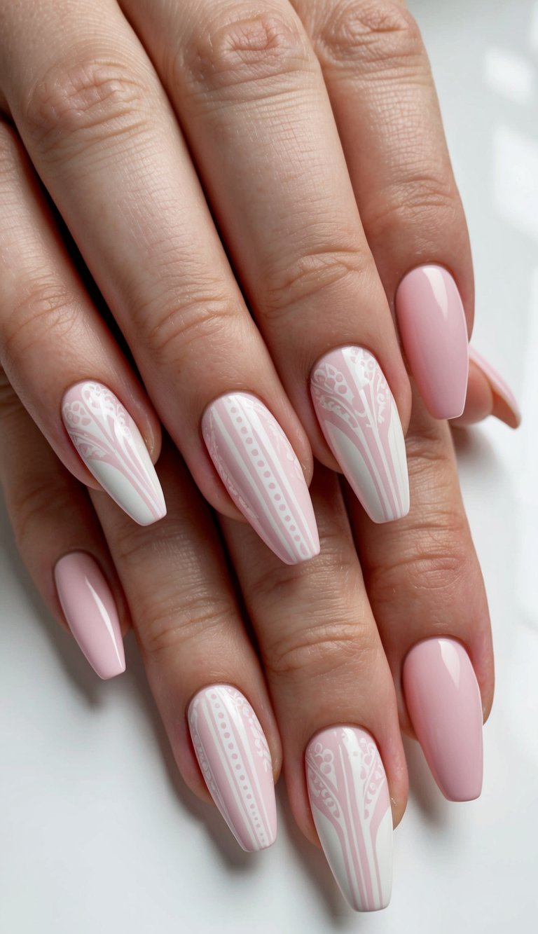 A pastel pink and white nail art design with delicate patterns and intricate details