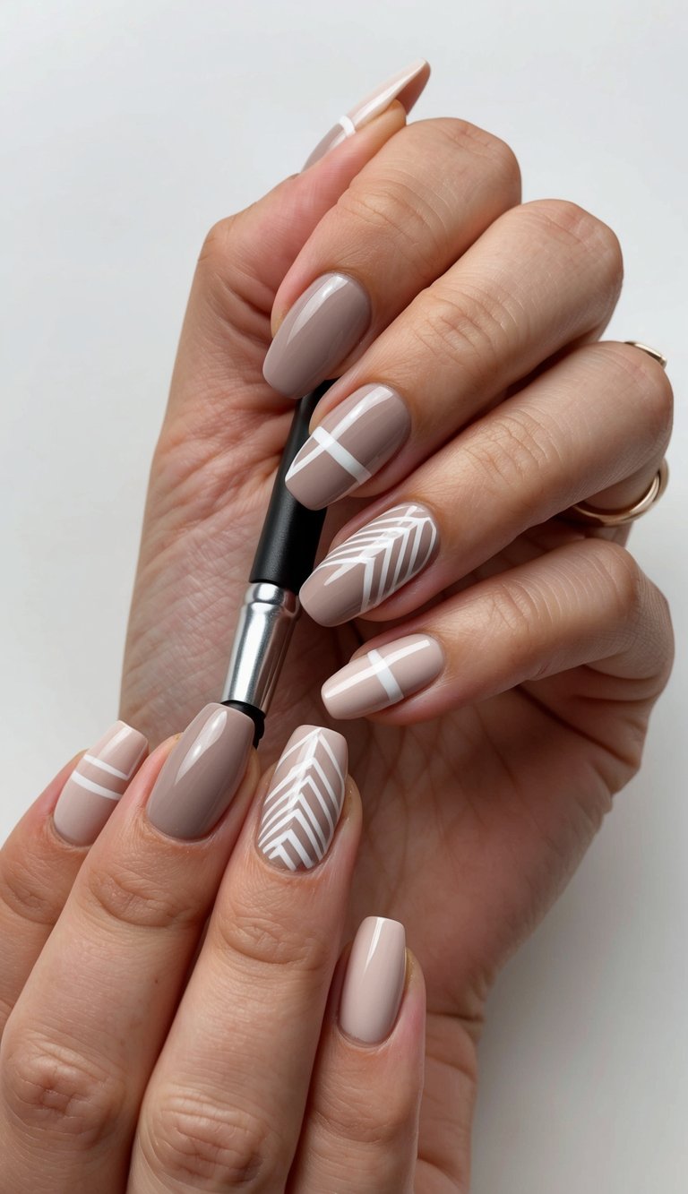 A hand holding a nail polish brush, creating geometric designs on neutral-colored nails