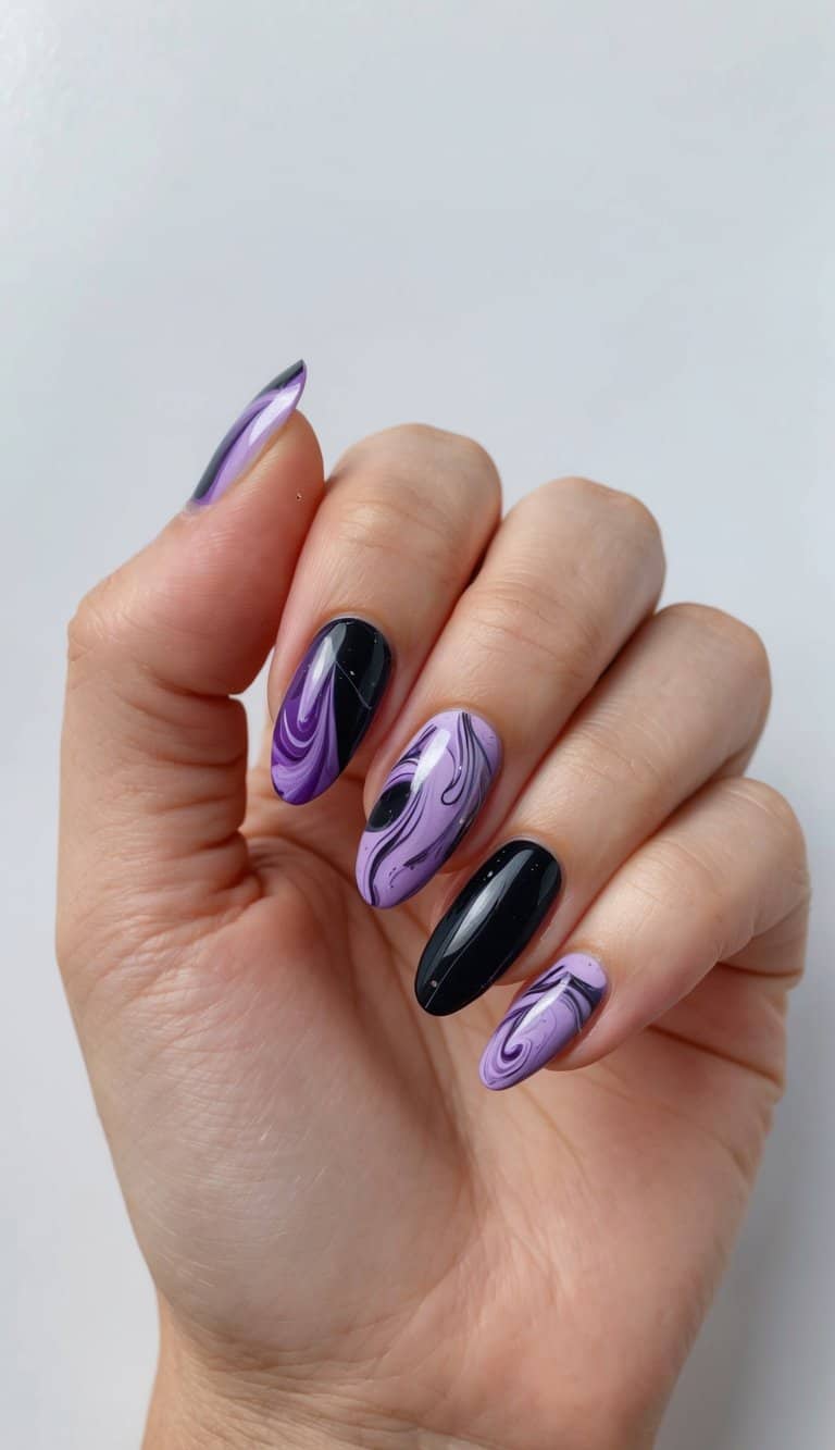 A swirling mix of purple and black marbles on a nail