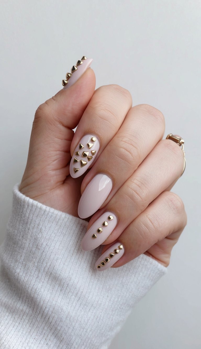 A close-up of a hand with studded punky nails in a plain nail art style