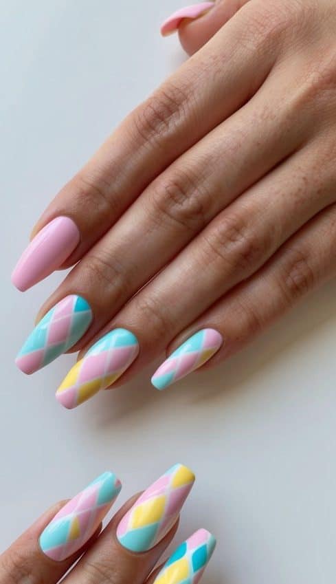 A colorful geometric pattern of pastel nail art designs on a clean, manicured surface