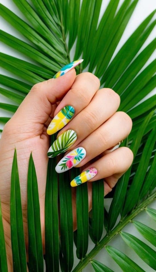 Vibrant tropical palm leaves arranged around colorful spring nail art designs