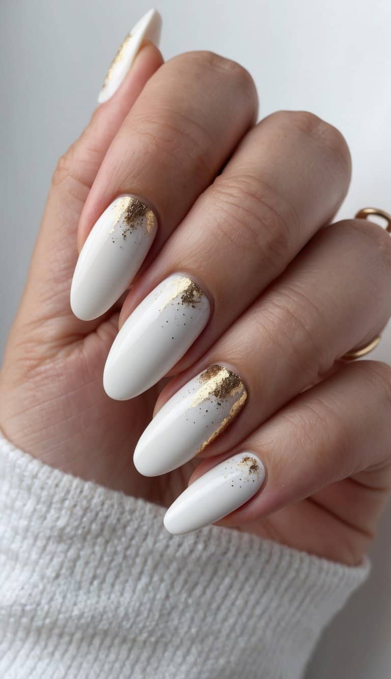White nails with delicate gold dust accents. Elegant and luxurious nail art inspiration