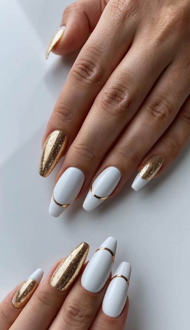 White and gold nail art designs arranged on a sleek, modern surface