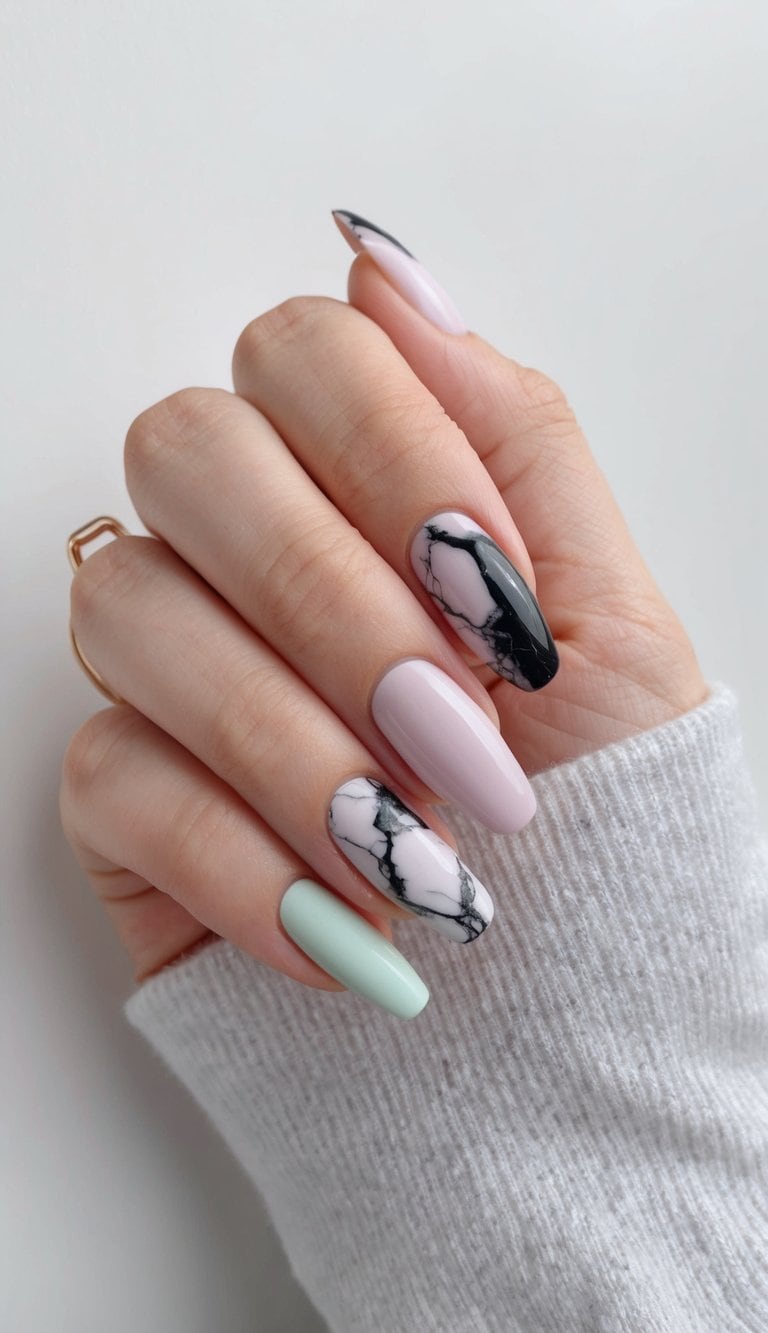 Soft pastel nails with black marble effect, minimalist aesthetic