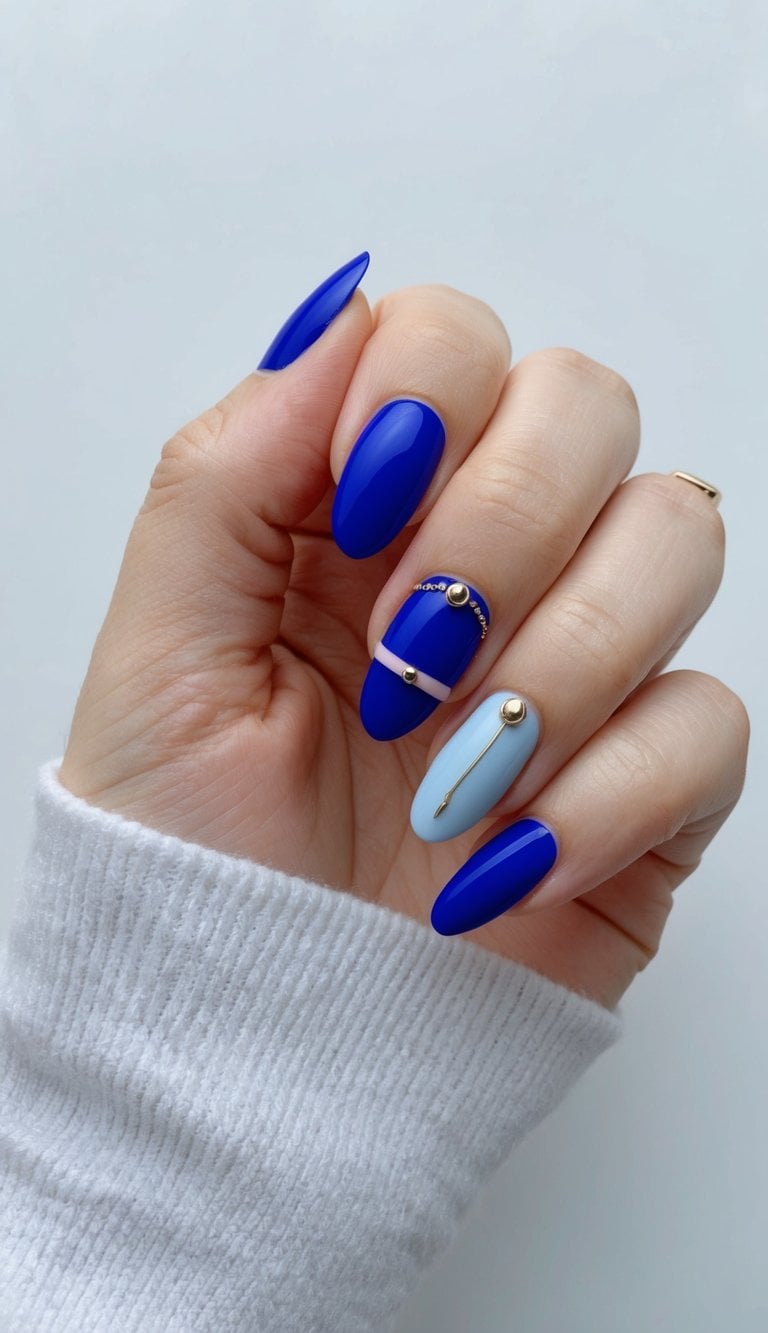 A royal blue nail art design with soft pastel accents and minimalist details