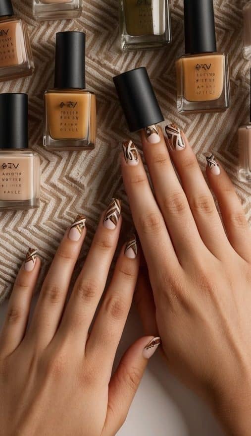 Earthy-toned nail polish bottles arranged with tribal patterns on a matte background