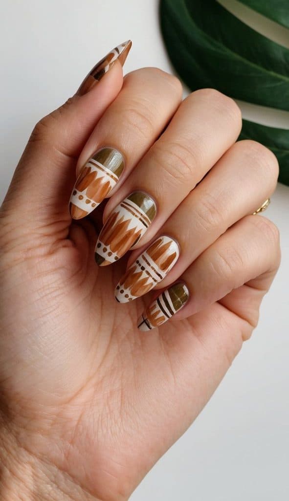 A close-up of boho-inspired nails with earthy tones and tribal patterns