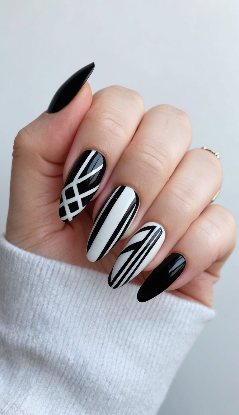 A sleek black and white nail art design featuring bold and edgy patterns and shapes