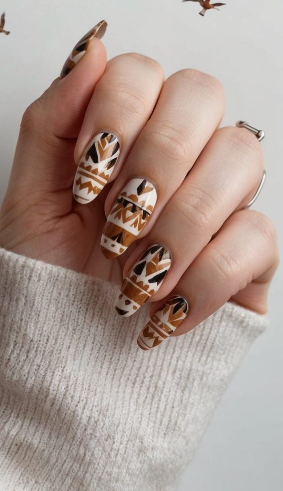 Birds in flight over earthy-toned tribal patterns for boho nail art