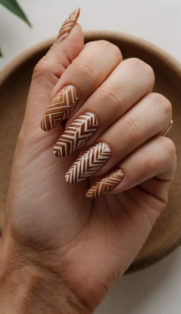 A collection of earthy toned tribal patterned nail art on display in a natural setting