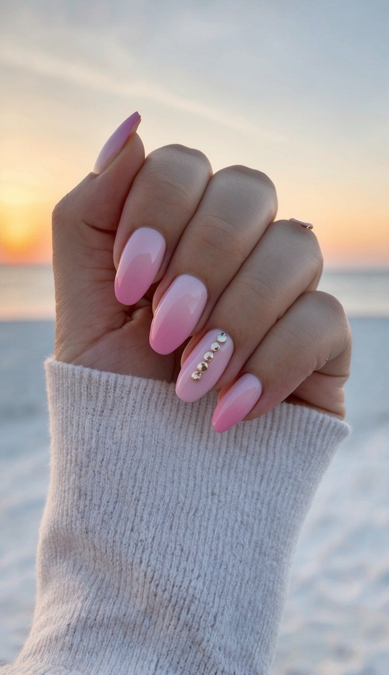 Soft pink ombre nails with a sunset backdrop