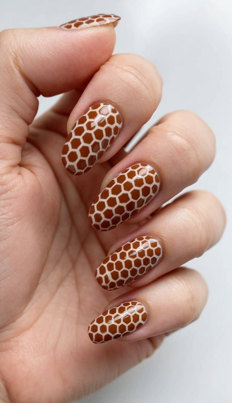 A close-up of honeycomb patterns in warm brown nail art