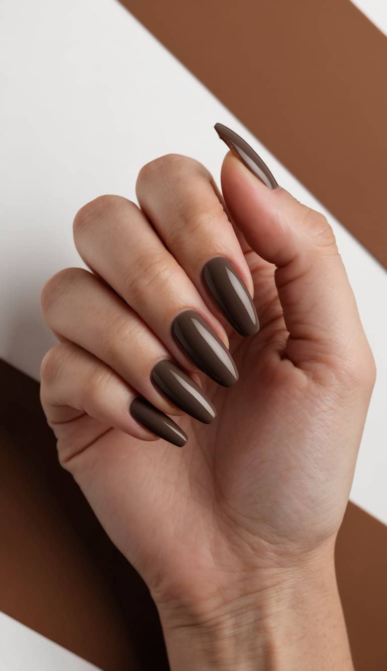 A hand with sable French tips surrounded by earthy brown tones and warm accents