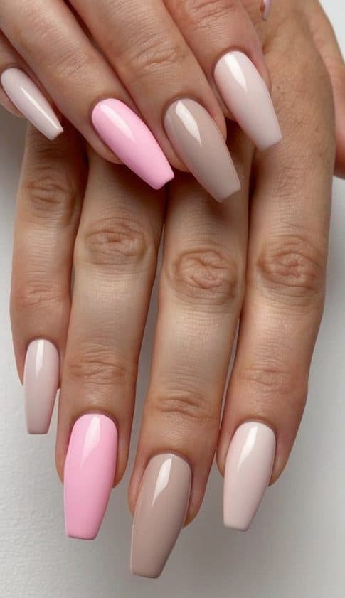 A clean, minimalist nail art design featuring neutral tones and subtle pops of bubblegum pink
