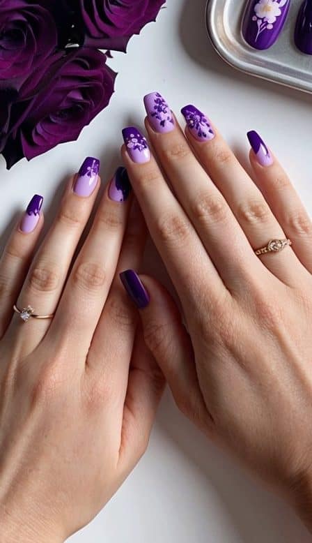 A bouquet of dark purple roses next to a tray of cute purple nail art designs