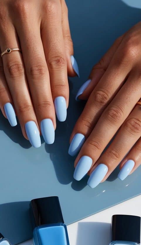 A close-up of cute blue nail art featuring glossy pastel blue nails with a smooth and even finish, creating a classic and elegant look.