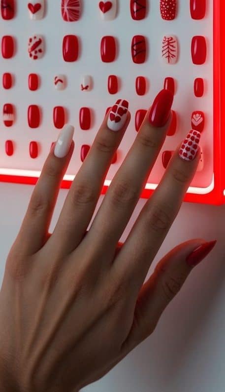 A red neon sign illuminates a display of 50 cute red nail art ideas, creating a bold and charming scene