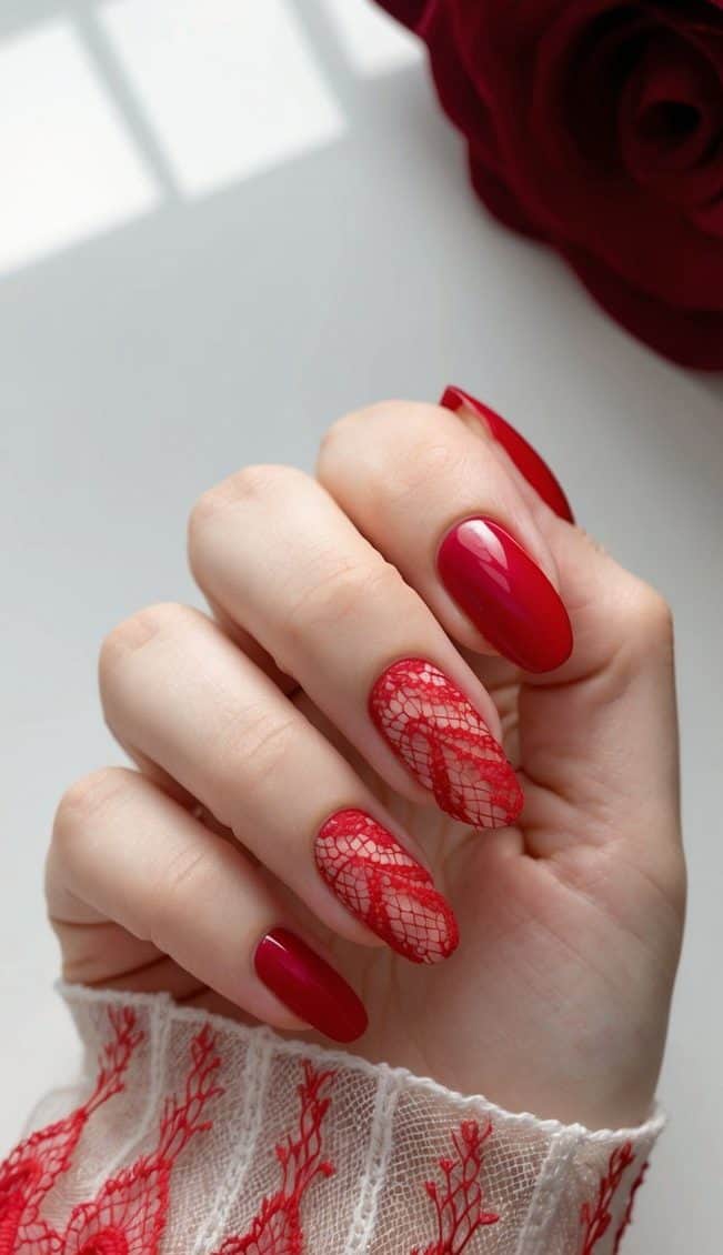A close-up of red lace nail art on a white background
