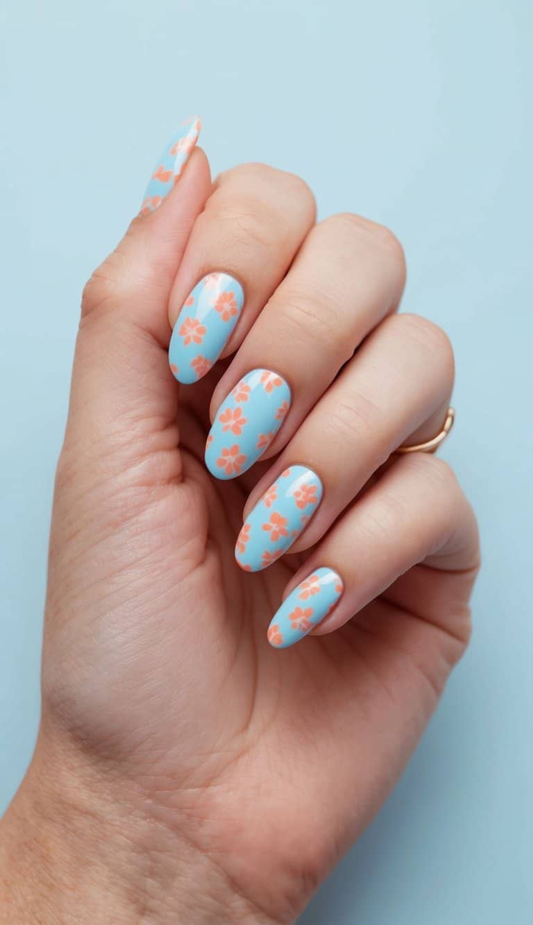 A soft blue nail design featuring delicate peach flowers, creating a dreamy and feminine manicure with a pastel aesthetic.