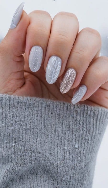 A cozy winter nail design featuring silver, white, and champagne shimmer with delicate snowflake details, perfect for December nail art ideas.